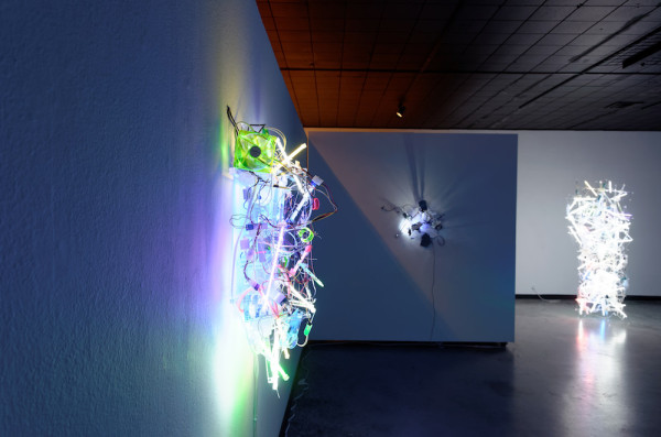 Gallery View with Hybrid Auto, flexible mirrors, gear motors, USB hub, USB LED lights, USB flex fans, laser printer alignment mirrors, Plexiglas, 27 x 29 x 12 inches, 2013. Photo courtesy of Women & Their Work. 