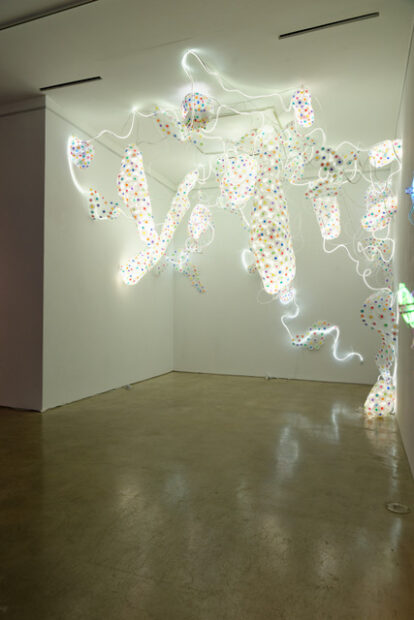 3d printed sculpture with LED lights mounted from floor to celing